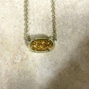 A gold glittery Kendra Scott necklace